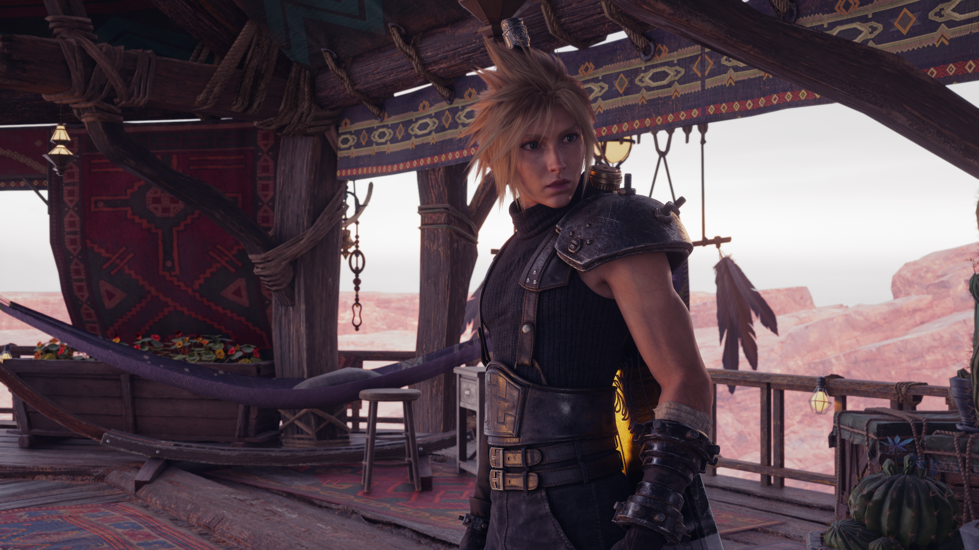 Cloud Strife from Final Fantasy VII Rebirth in a desert outpost, wind-tossed hair and armor — cinematic 4K Ultra HD PC desktop wallpaper/background.