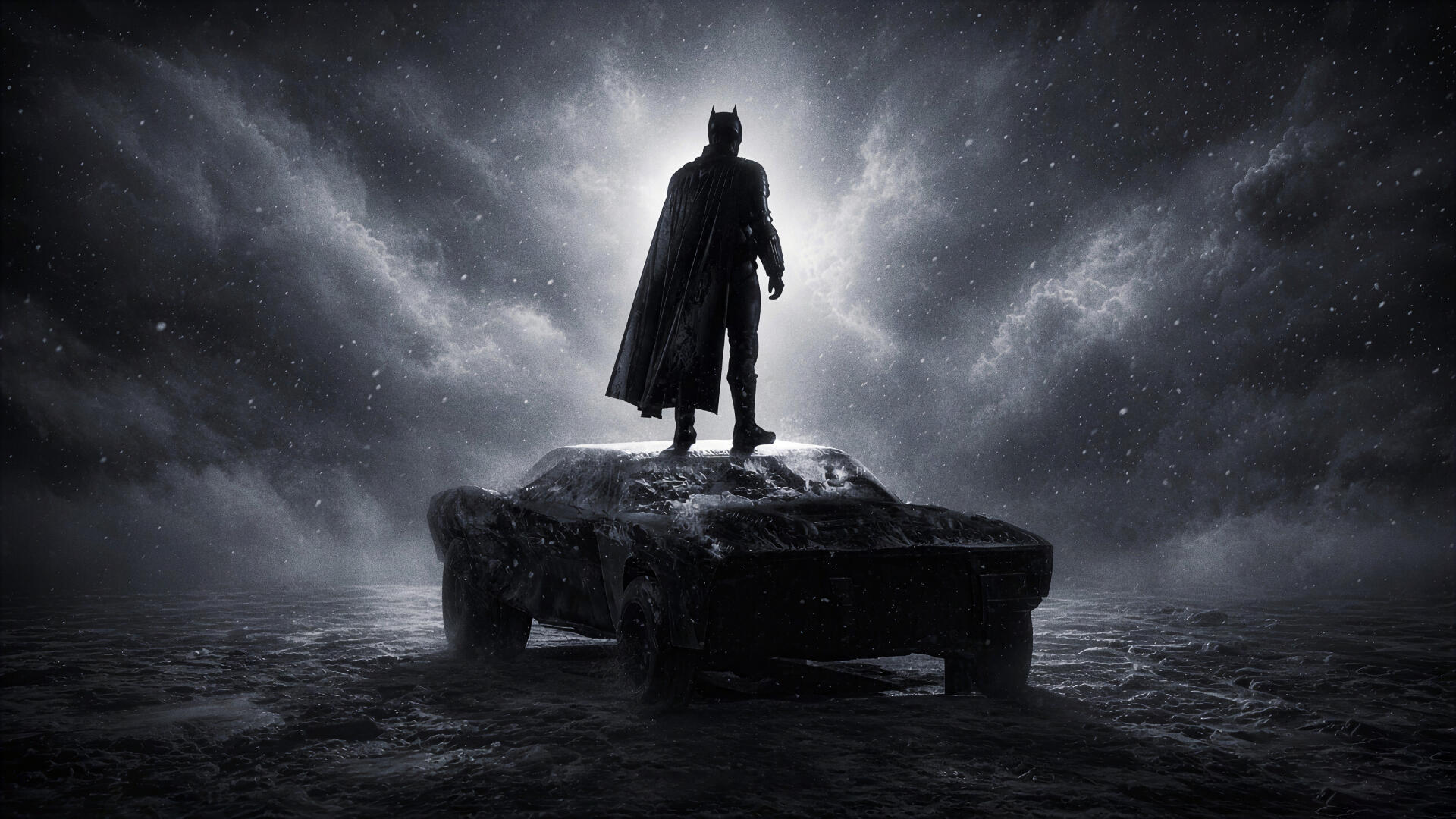 Dark 4K Ultra HD PC desktop wallpaper/background: Batman silhouette standing on a battered Batmobile beneath stormy skies, evoking a contemporary cinematic actor's portrayal.