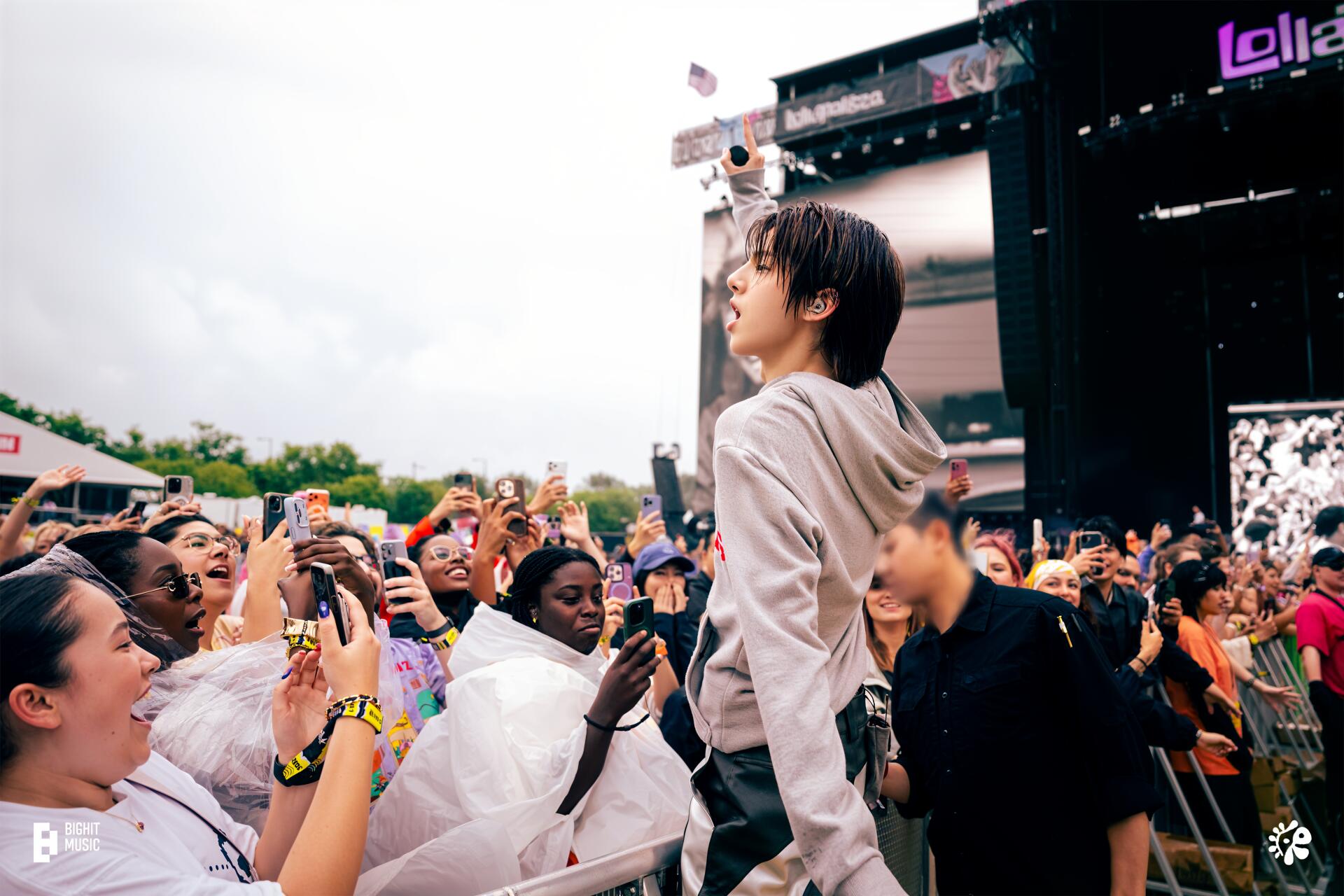 Singer leaning into an ecstatic festival crowd at the Cortis concert, hands raised and phones out, vibrant 4K Ultra HD PC desktop wallpaper and background.