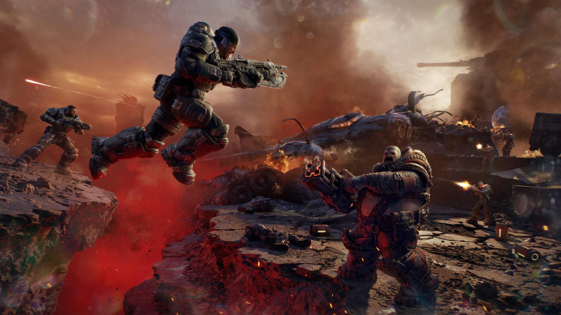 2K Quad HD PC wallpaper of Gears of War: E-Day — Marcus Fenix and soldiers storm a fiery battlefield amid explosions and wreckage.