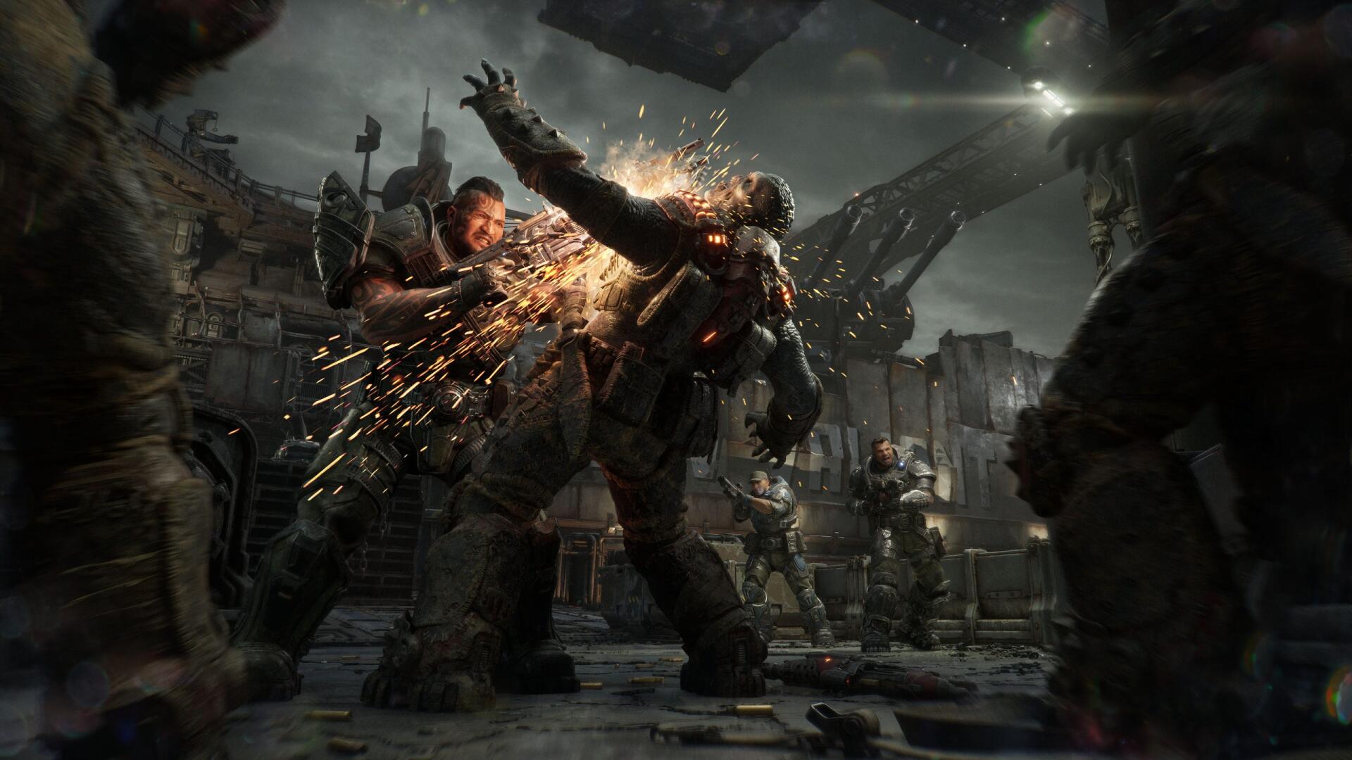 Gears of War: E-Day — armored warriors clash in an explosive urban battle as one soldier chainsaws an enemy; 2K Quad HD PC desktop wallpaper/background.