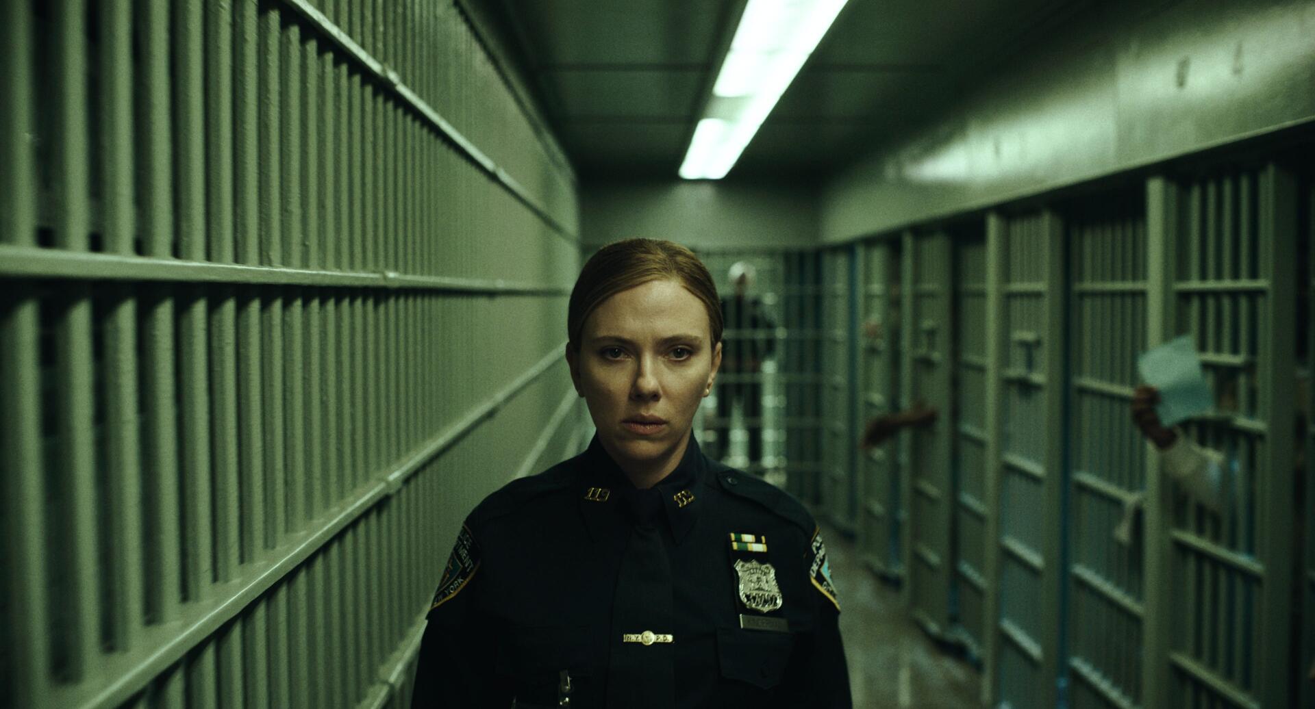 Scarlett Johansson as a police officer in a dim hallway in The Exorcist: Martyrs, 2K Quad HD desktop wallpaper.