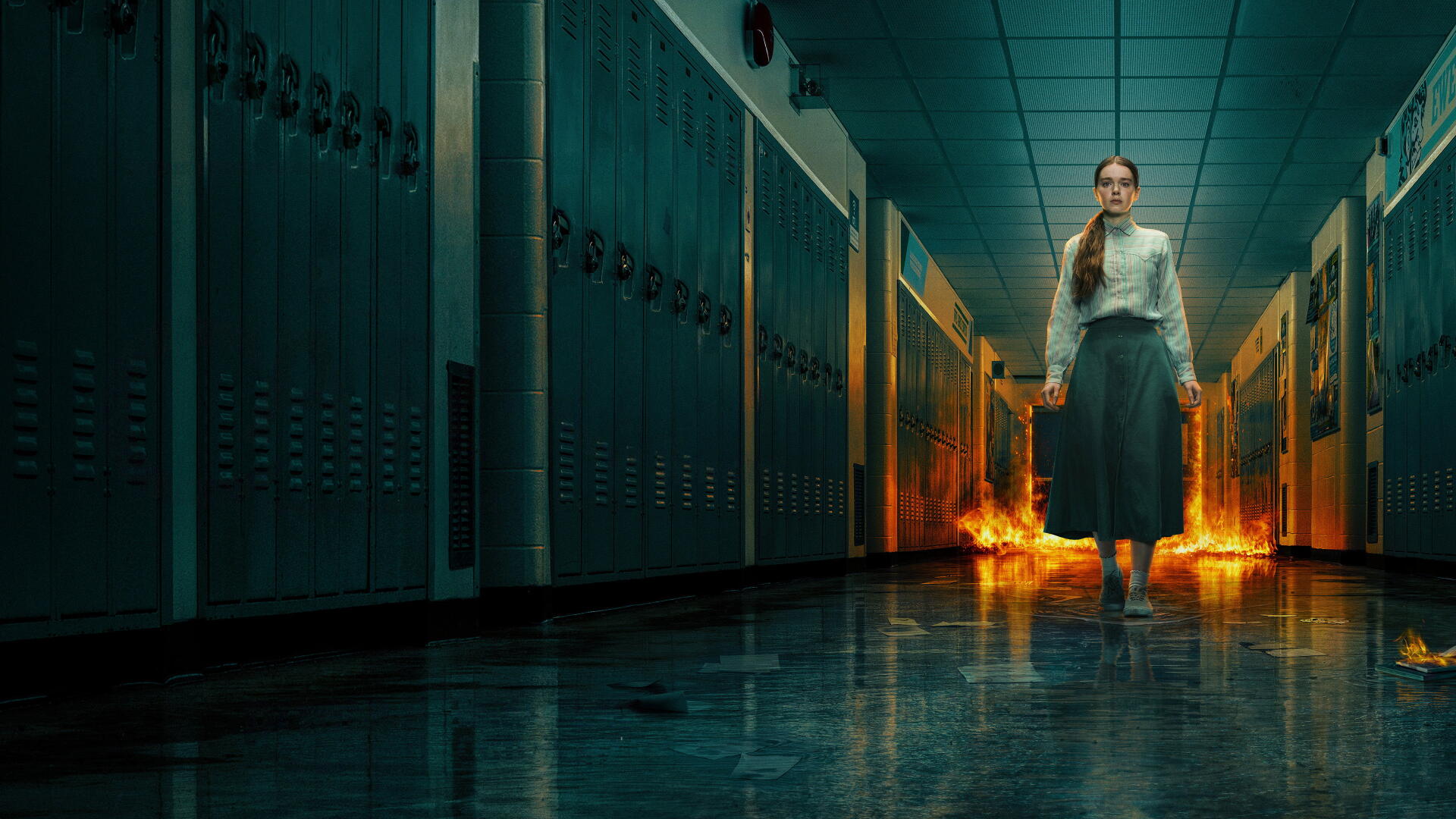 Carrie (Prime Video) 4K Ultra HD PC desktop wallpaper showing a girl in a school hallway with flames blazing behind her.