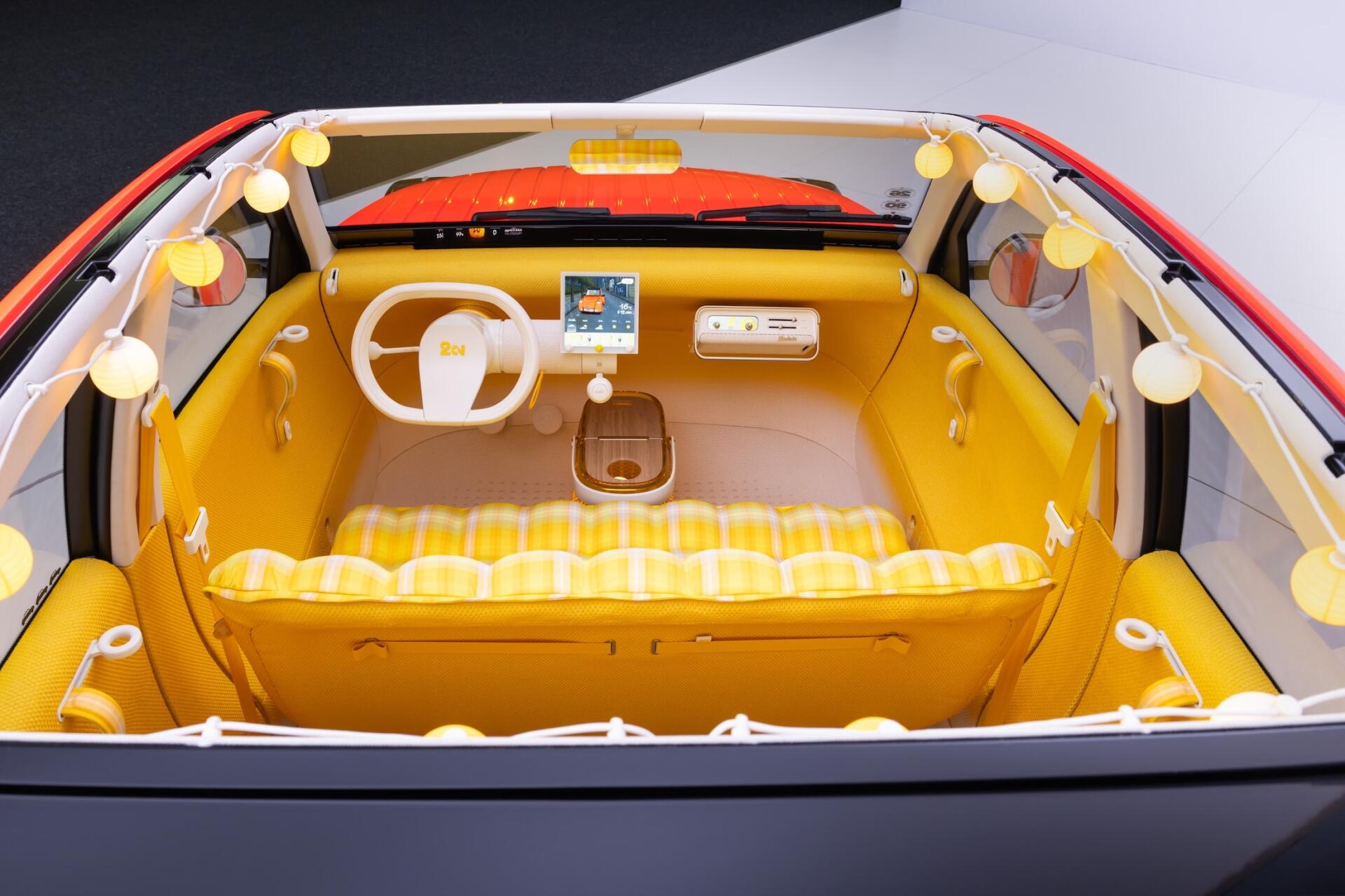 HD desktop wallpaper of the Citroën 2CV concept car interior, featuring a white steering wheel and bright yellow cabin.