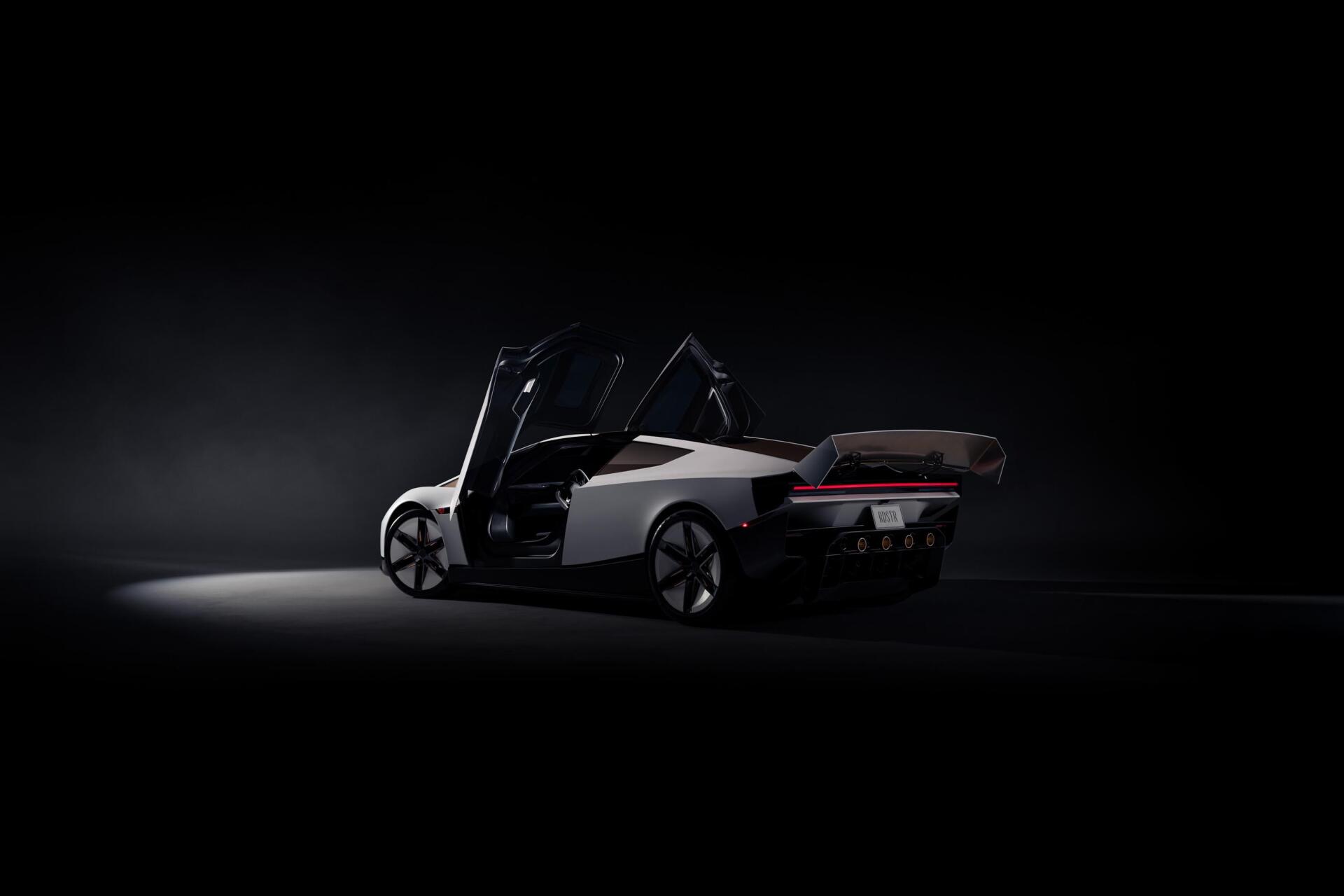 Tesla electric sports car with doors open in a dark studio, 2K Quad HD desktop wallpaper