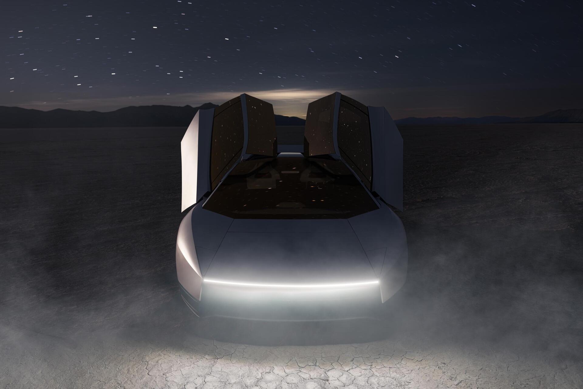 Futuristic Tesla Roadster with glowing headlights in a dark, misty scene, featured in a 2K Quad HD PC desktop wallpaper background.