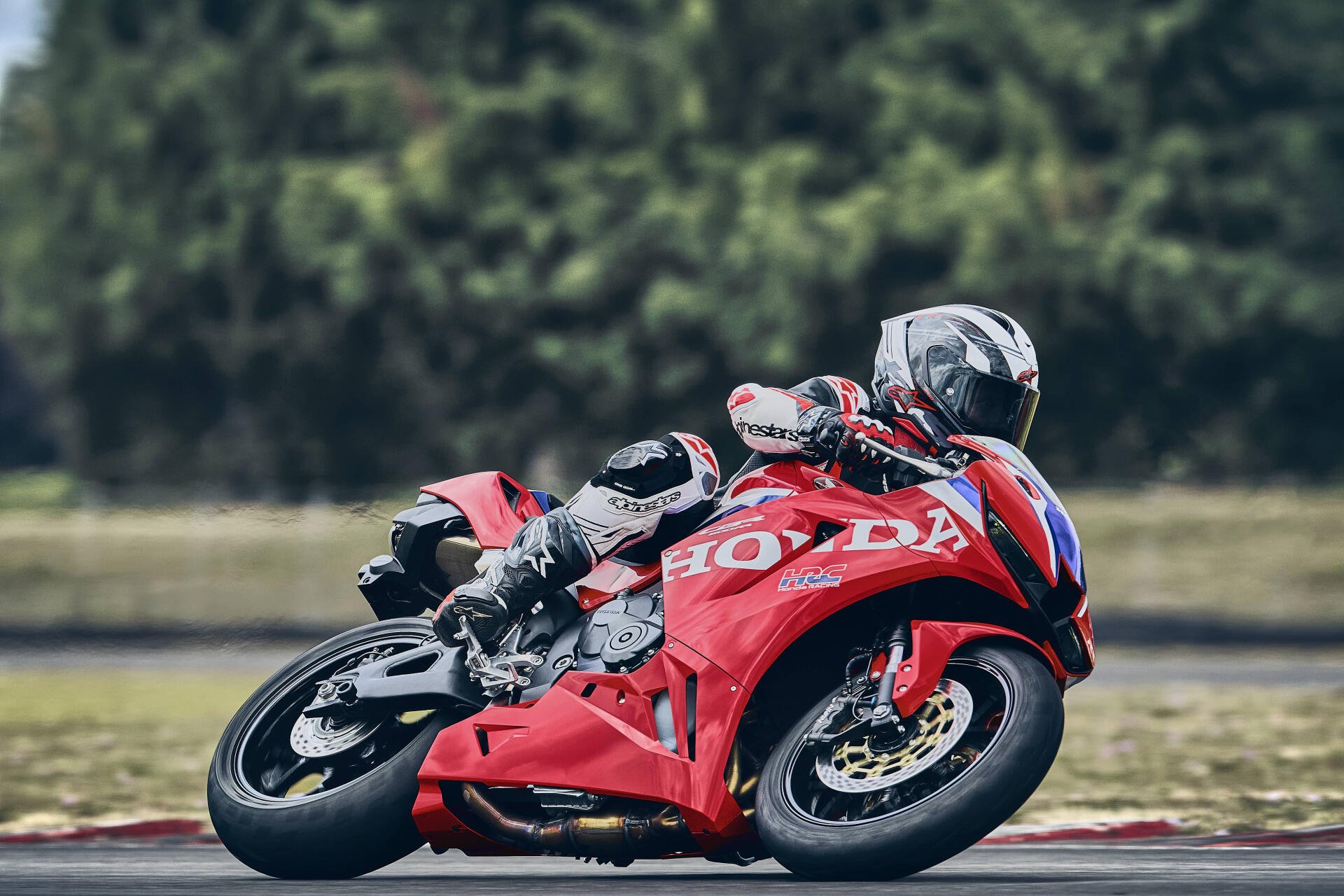 Honda CBR600RR racing motorcycle leaning through a track corner, featured in a 4K Ultra HD PC desktop wallpaper and background.