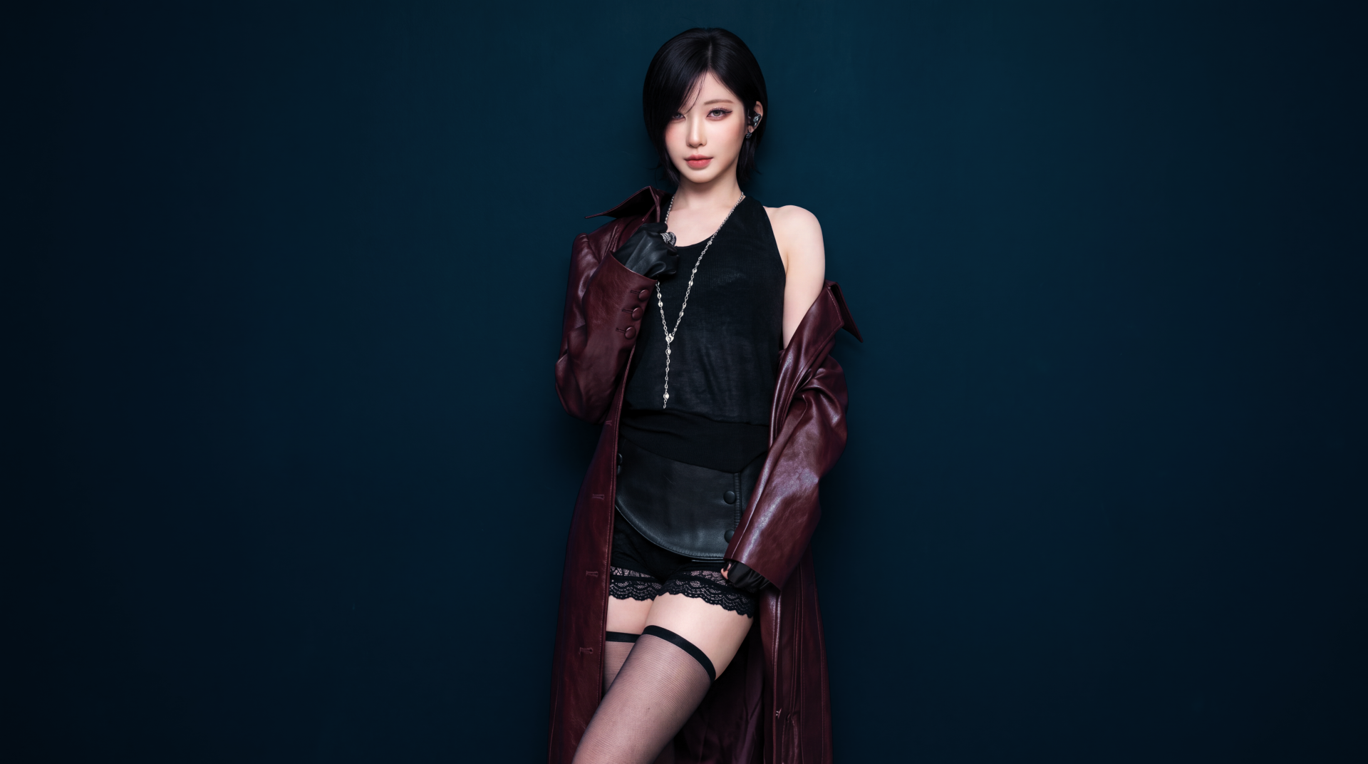 BABYMONSTER K-pop star Asa in a burgundy coat, black outfit, and thigh-high stockings against a dark blue backdrop, 5K Ultra HD desktop wallpaper.