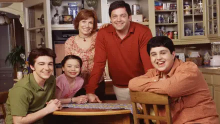Drake & Josh HD PC desktop wallpaper: cast family portrait in a cozy kitchen, two teen boys and their parents smiling around a table.