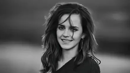 Black-and-white headshot of a smiling young woman with windblown hair against a soft backdrop — 5K Ultra HD PC desktop wallpaper and background.