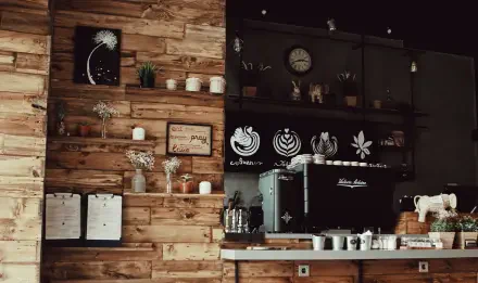Espresso Fall cozy cafe interior with warm wood wall, shelves, chalkboard art and black espresso machine — 5K Ultra HD PC desktop wallpaper background.
