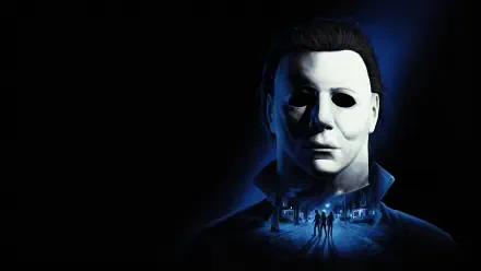 4K Ultra HD PC wallpaper of Michael Myers (Halloween: The Game) — his white mask looms in blue light over a dark suburban street with small silhouetted figures, emitting classic horror dread.