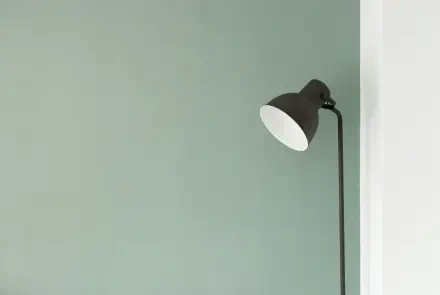 Minimal electric yellow aesthetic floor lamp against a pale muted wall — 4K Ultra HD PC desktop wallpaper and background.