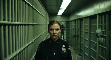 Scarlett Johansson as a police officer in a dim hallway in The Exorcist: Martyrs, 2K Quad HD desktop wallpaper.