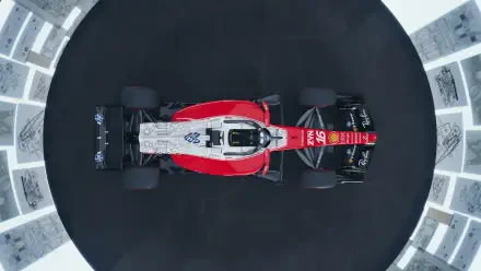 Overhead view of the Ferrari SF-26 Formula One race car on a dark circular track, 4K Ultra HD PC desktop wallpaper.