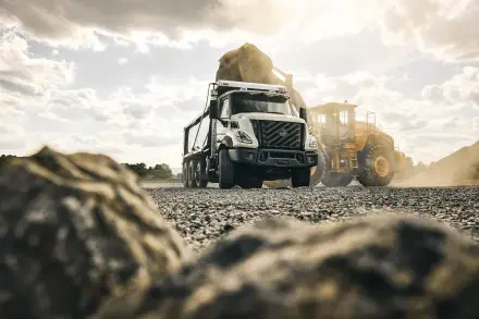 Volvo VNX construction truck on a rugged worksite, featured in an 8K Ultra HD PC desktop wallpaper background.