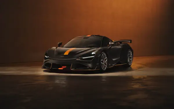 Sleek black McLaren 788HS sports car with orange accents in dim studio lighting, 8K Ultra HD PC desktop wallpaper/background.