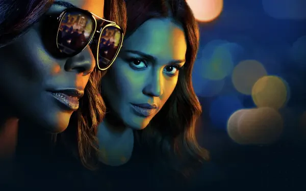 HD PC desktop wallpaper for L.A.'s Finest: close-up of two female detectives—one in sunglasses—bathed in moody blue light with blurred city bokeh in the background.
