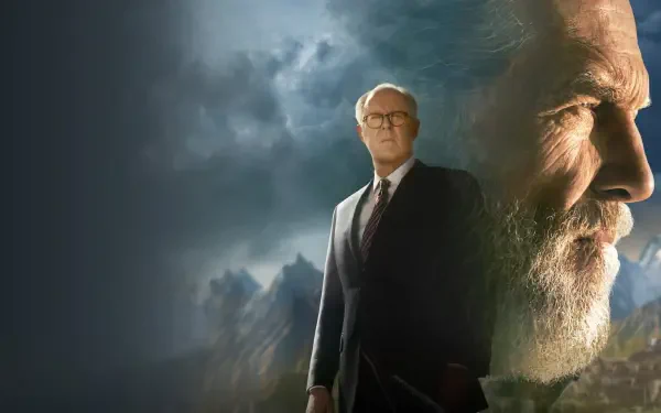 4K Ultra HD PC desktop wallpaper titled The Old Man — close-up bearded old man's profile and a full-body suited figure set against moody, stormy clouds and mountains.