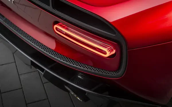 Close-up of the rear taillight and bumper of a red McLaren McL 6GT sports car, 8K Ultra HD PC desktop wallpaper background.