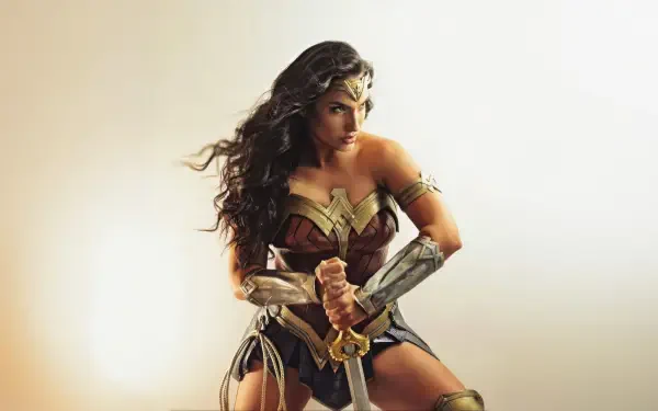 Wonder Woman superhero cosplay: armored heroine holding a sword in a dramatic pose — 5K Ultra HD PC desktop wallpaper/background.