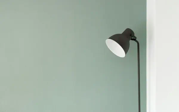 Minimal electric yellow aesthetic floor lamp against a pale muted wall — 4K Ultra HD PC desktop wallpaper and background.
