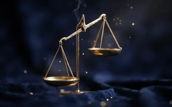 2K Quad HD PC desktop wallpaper/background: Libra (astrology) golden scales hovering over dark velvet, symbolizing justice and law.