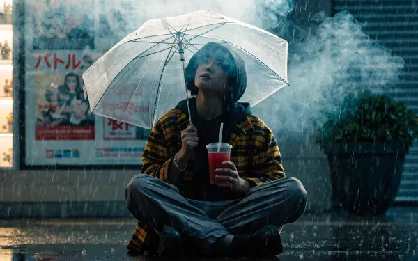 Otaku-inspired 2K Quad HD PC desktop wallpaper of a woman sitting in the rain beneath a clear umbrella, holding a drink.