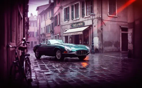 Classic Jaguar convertible on a rain-soaked city street, 4K Ultra HD desktop wallpaper and background.