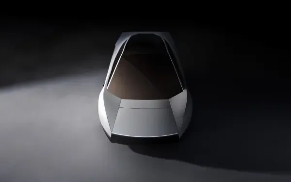 Front view of a silver Tesla Roadster concept car in a dark studio, 2K Quad HD PC desktop wallpaper and background.