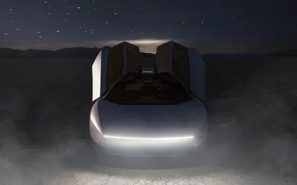 Futuristic Tesla Roadster with glowing headlights in a dark, misty scene, featured in a 2K Quad HD PC desktop wallpaper background.