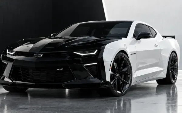 Black and white Chevrolet Camaro sports car on a studio floor, featured in a 4K Ultra HD PC desktop wallpaper and background.
