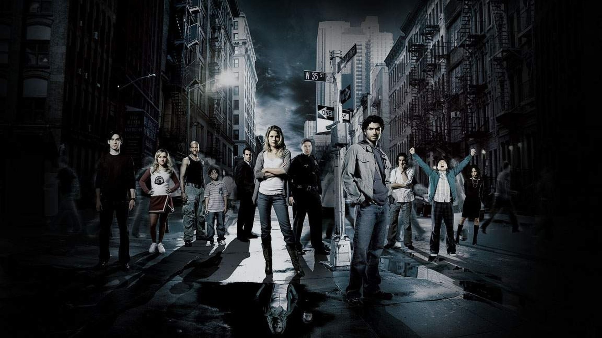HD PC desktop wallpaper featuring the main cast of the TV show Heroes standing in a dark, rainy urban street setting.