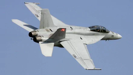 HD desktop wallpaper of a McDonnell Douglas F/A-18 Hornet military jet flying against a clear blue sky.