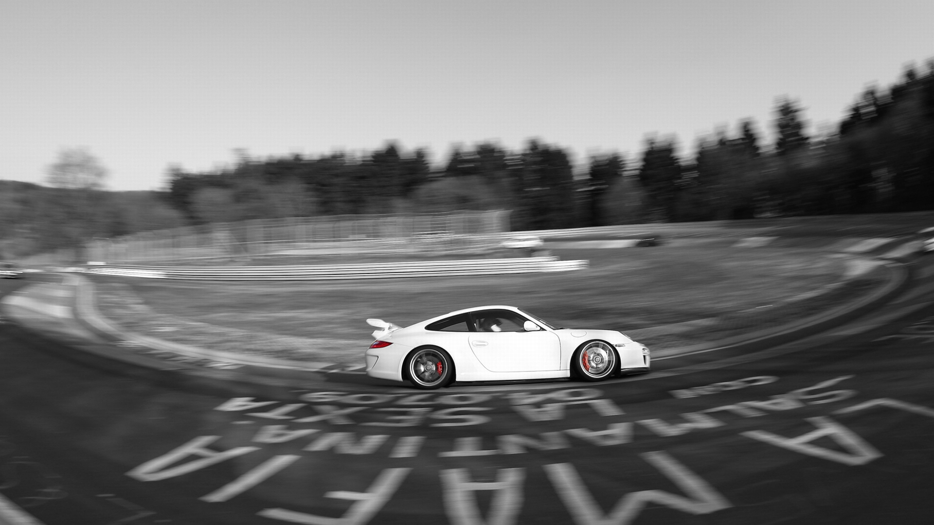 A sleek white Porsche speeding down a curvy road, exuding power and elegance.