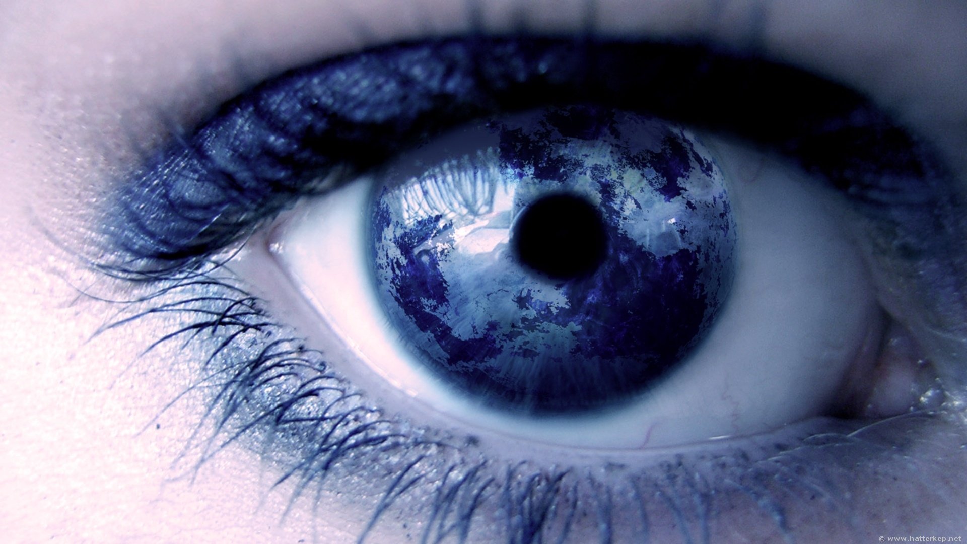 Close-up of an artistic blue eye with detailed texture, designed as an HD PC desktop wallpaper and background.