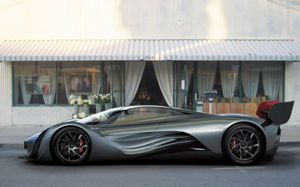Sleek silver Mazda Furai concept vehicle side view against a storefront — high-resolution HD PC desktop wallpaper/background.