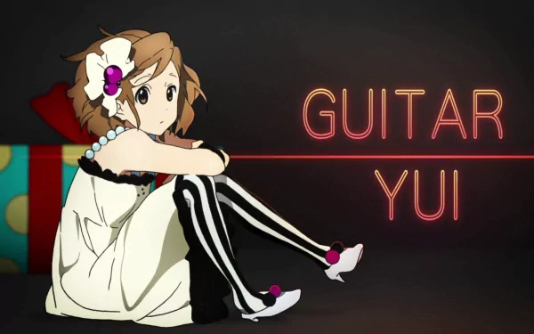 HD desktop wallpaper featuring Yui Hirasawa from the anime K-ON!, showcasing her playful expression alongside bold text reading GUITAR YUI.