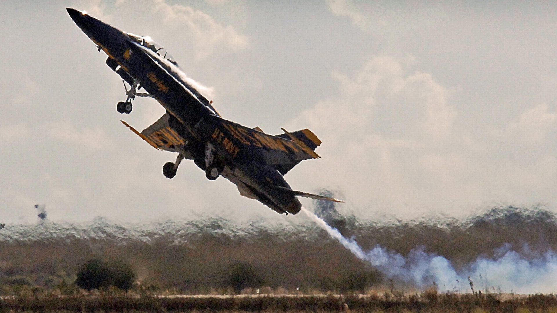 A military jet performing a high-speed takeoff at an air show, captured in HD for a dynamic PC desktop wallpaper background.