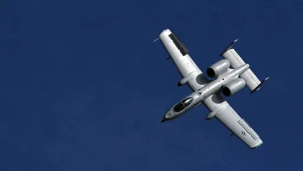 Military Fairchild Republic A-10 Thunderbolt II in flight against a deep blue sky — HD PC desktop wallpaper/background.