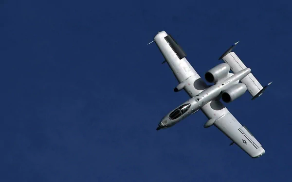 Military Fairchild Republic A-10 Thunderbolt II in flight against a deep blue sky — HD PC desktop wallpaper/background.
