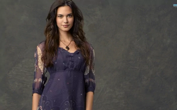 HD desktop wallpaper featuring celebrity Odette Annable, showcasing her in a stylish outfit with flowing hair against a textured background.