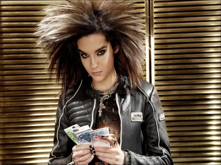 HD PC desktop wallpaper featuring a striking portrait of Tokio Hotel's lead singer with bold hair and intense gaze, set against a wooden slatted background.