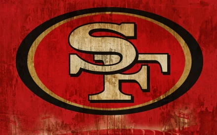 HD desktop wallpaper featuring the San Francisco 49ers logo with a textured red background, highlighting the iconic sports team emblem.