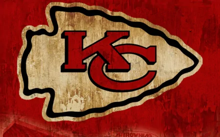 An HD desktop wallpaper featuring the Kansas City Chiefs logo on a textured red background, embodying the spirit of sports and team pride.