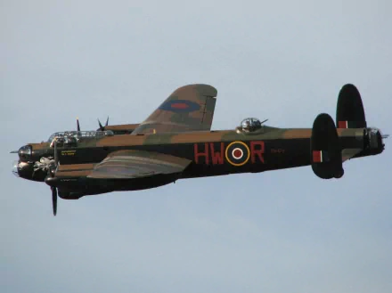 HD PC desktop wallpaper/background showing a military aircraft: vintage bomber in flight with camouflage and RAF roundel, side profile against a pale sky.