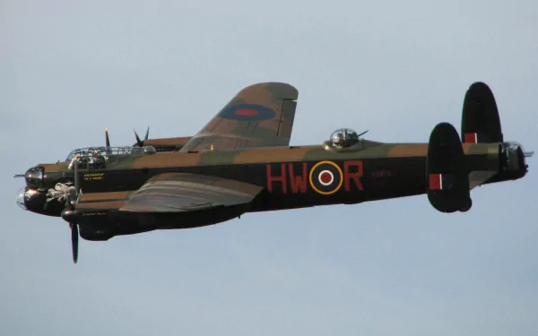HD PC desktop wallpaper/background showing a military aircraft: vintage bomber in flight with camouflage and RAF roundel, side profile against a pale sky.