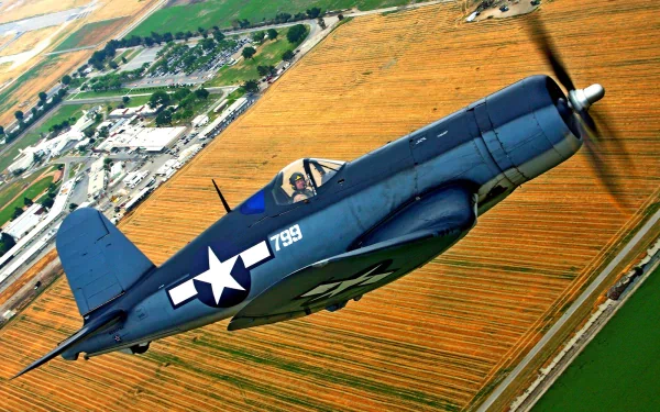 HD desktop wallpaper showing a vintage military aircraft flying over farmland with clear skies and detailed landscape below.