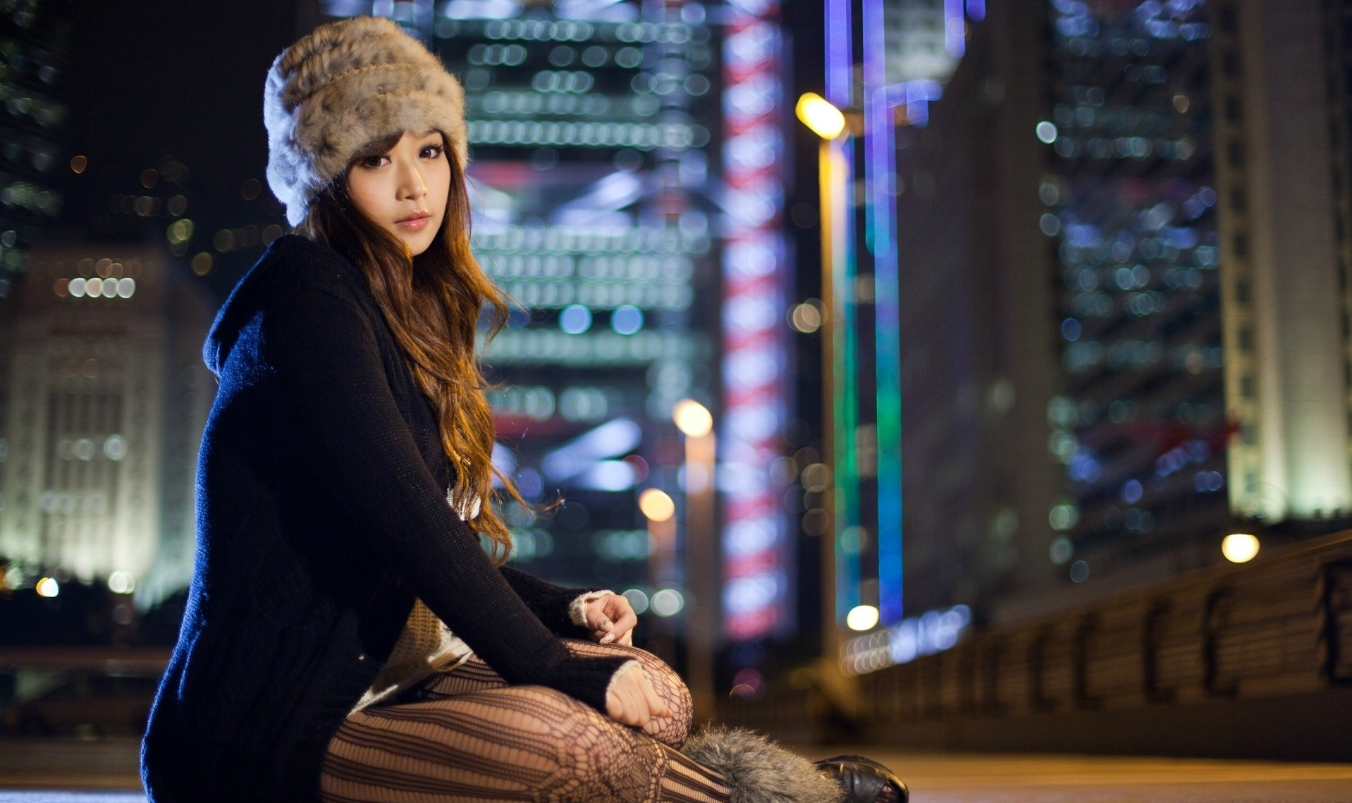 Asian woman in a stylish hat and fur clothing, long brown hair, brown eyes, wearing thigh highs.