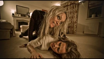 HD PC desktop wallpaper from the movie Dead Cert, featuring a tense scene with a pale woman pinning down another in a dimly lit room.